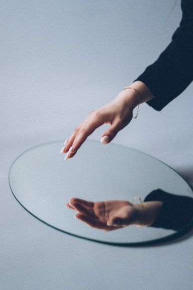 Hand infront of mirror